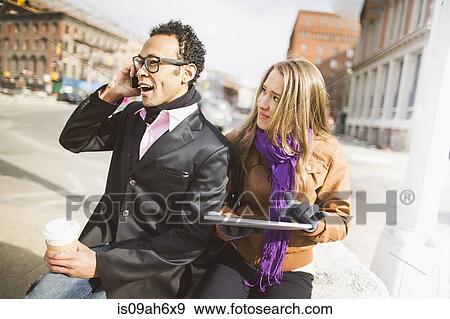Young couple with cellphone and digital tablet in New York, USA View Large Photo Image Stock Photo - Young couple with cellphone and digital tablet in New York, USA. Fotosearch