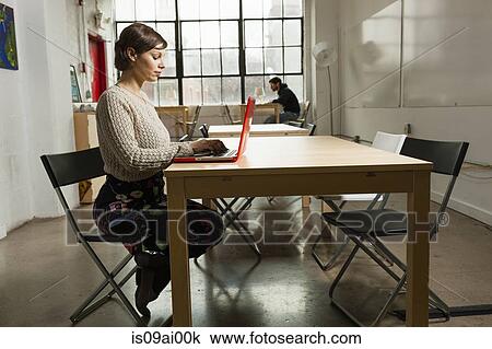 Young female designer busy on laptop in design studio View Large Photo Image Stock Image - Young female designer busy on laptop in design studio. Fotosearch