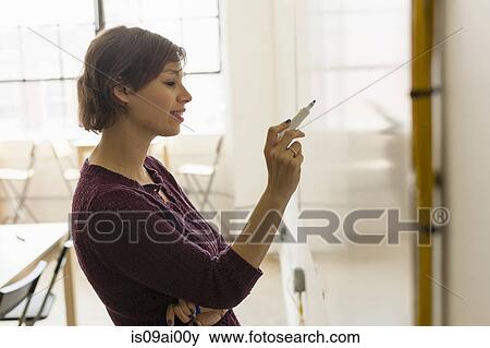 Young female designer drawing on whiteboard in studio View Large Photo Image Stock Photo - Young female designer drawing on whiteboard in studio. Fotosearch