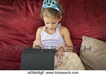 Young girl using touchscreen on digital tablet View Large Photo Image Stock Photograph - Young girl using touchscreen on digital tablet. Fotosearch
