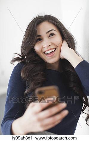 Young woman using smartphone View Large Photo Image Stock Image - Young woman using smartphone. Fotosearch
