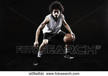 Basketball player bouncing basketball View Large Photo Image Stock Photo - Basketball player bouncing basketball. Fotosearch