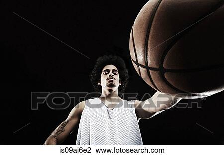 Basketball player holding basketball, low angle View Large Photo Image Stock Image - Basketball player holding basketball, low angle. Fotosearch
