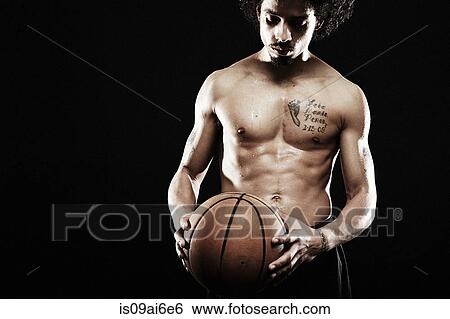 Basketball player holding basketball View Large Photo Image Stock Photograph - Basketball player holding basketball. Fotosearch
