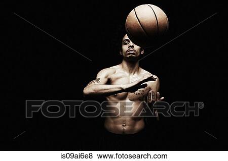 Basketball player throwing basketball View Large Photo Image Stock Photo - Basketball player throwing basketball. Fotosearch