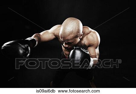 Stock Image - Boxer punching. Fotosearch