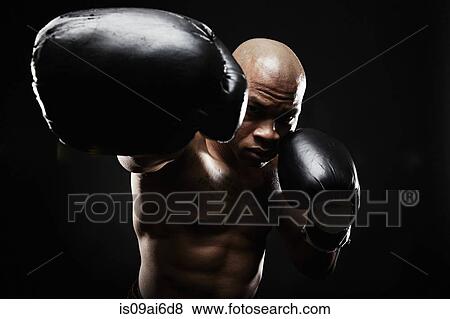 boxer-with-black-boxing-gloves-punching-stock-photo__is09ai6d8.jpg