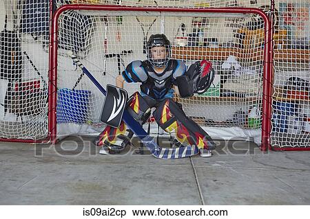 Boy in hockey goal wearing protective sportswear View Large Photo Image Stock Photography - Boy in hockey goal wearing protective sportswear. Fotosearch
