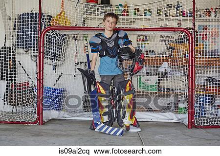 Boy in hockey goal wearing protective sportswear View Large Photo Image Stock Photography - Boy in hockey goal wearing protective sportswear. Fotosearch