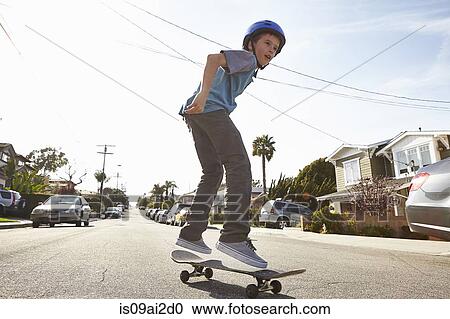 Boy skateboarding on road View Large Photo Image Stock Image - Boy skateboarding on road. Fotosearch