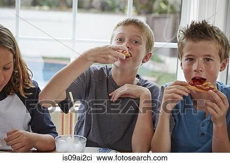 Boys eating pizza View Large Photo Image Stock Image - Boys eating pizza. Fotosearch