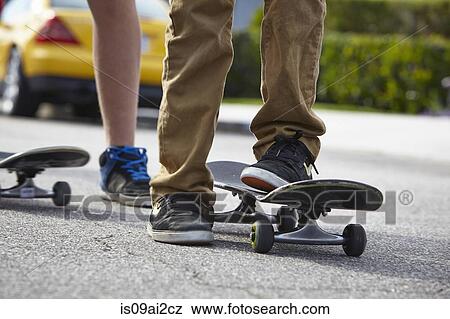 Stock Photo - Boys skateboarding, close up. Fotosearch