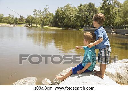 Picture - Brothers enjoying lake, Newport Beach, California, USA. Fotosearch