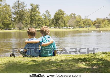 Stock Image - Brothers enjoying lakeside, Newport Beach, California, USA. Fotosearch