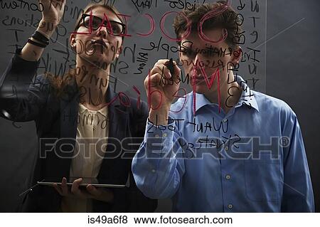 Stock Photo - Business colleagues writing on glass. Fotosearch
