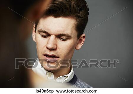 Stock Photography - Candid portrait of young man close up. Fotosearch