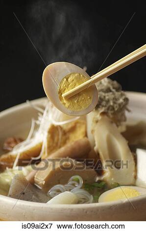 Chopstick picking up egg from bowl of noodles View Large Photo Image Stock Photo - Chopstick picking up egg from bowl of noodles. Fotosearch