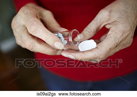 Close up of 82 year old senior woman's hand with pill bottle View Large Photo Image Stock Photograph - Close up of 82 year old senior woman's hand with pill bottle. Fotosearch