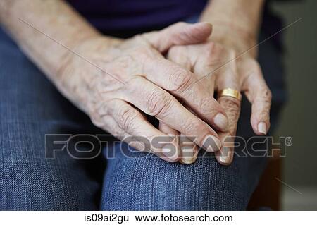 Stock Photograph - Close up of 82 year old senior woman's hands. Fotosearch