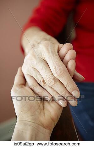Close up of mature woman holding 82 year old grandmothers hand View Large Photo Image Stock Photography - Close up of mature woman holding 82 year old grandmothers hand. Fotosearch