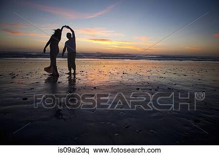 Couple dancing on beach at sunset, Cape Town, South Africa View Large Photo Image Stock Photography - Couple dancing on beach at sunset, Cape Town, South Africa. Fotosearch