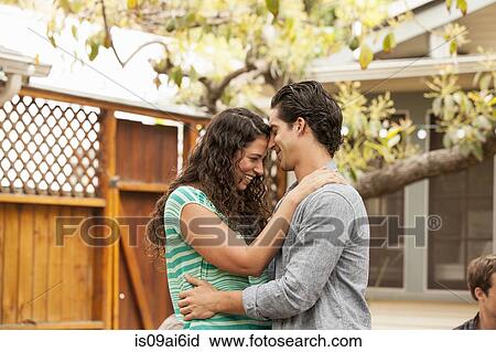 Stock Image - Couple in garden, face to face. Fotosearch