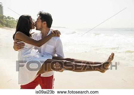 Stock Image - Couple kissing on Arpoador beach, Rio De Janeiro, Brazil. Fotosearch