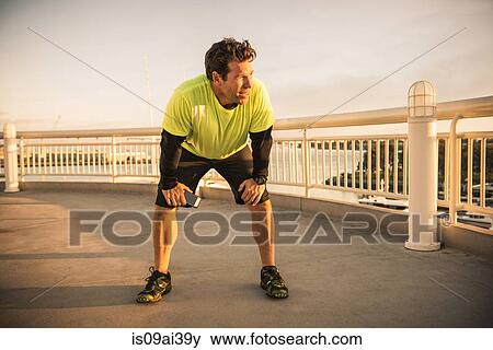 Exhausted male runner taking a break View Large Photo Image Stock Photo - Exhausted male runner taking a break. Fotosearch