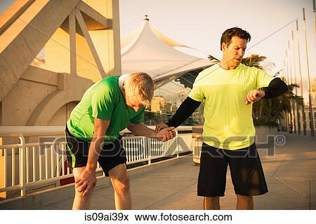 Exhausted male runner with trainer checking pulse View Large Photo Image Stock Photo - Exhausted male runner with trainer checking pulse. Fotosearch