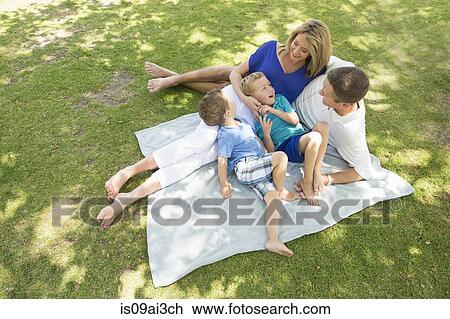Family of four on picnic blanket View Large Photo Image Stock Image - Family of four on picnic blanket. Fotosearch