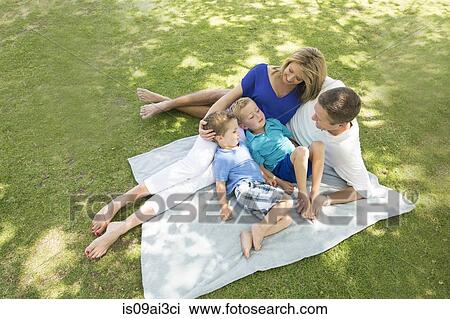 Family of four on picnic blanket View Large Photo Image Stock Image - Family of four on picnic blanket. Fotosearch