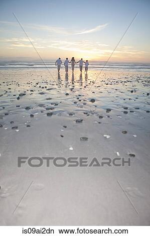 Family running towards sea at sunset, Cape Town, South Africa View Large Photo Image Picture - Family running towards sea at sunset, Cape Town, South Africa. Fotosearch