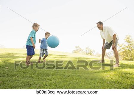 Father and sons playing ball at park View Large Photo Image Stock Photography - Father and sons playing ball at park. Fotosearch