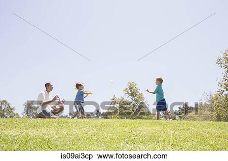 Father and sons playing baseball at park View Large Photo Image Stock Photography - Father and sons playing baseball at park. Fotosearch