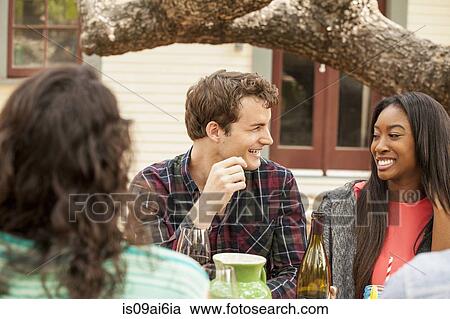 Friends with drinks at backyard barbecue View Large Photo Image Stock Image - Friends with drinks at backyard barbecue. Fotosearch
