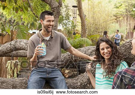 Stock Image - Friends with drinks at backyard barbecue. Fotosearch