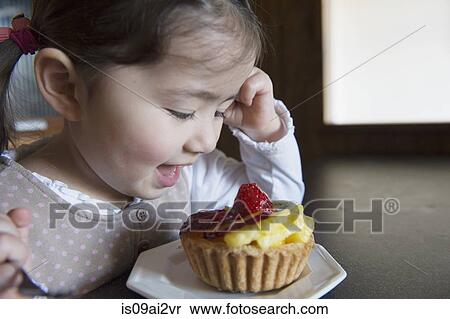 Stock Photography - Girl happy with her tart. Fotosearch