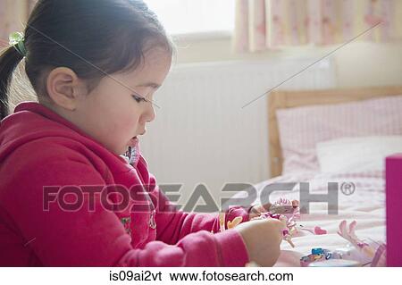 Girl playing by herself View Large Photo Image Stock Photograph - Girl playing by herself. Fotosearch