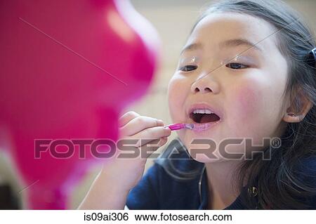 Girl putting make up on View Large Photo Image Stock Photograph - Girl putting make up on. Fotosearch