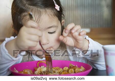 Stock Photography - Girl using fork. Fotosearch