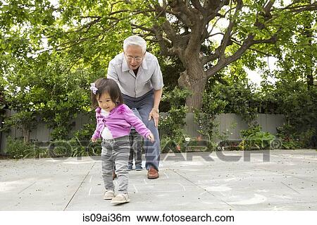 Grandfather playing hopscotch with toddler granddaughter View Large Photo Image Picture - Grandfather playing hopscotch with toddler granddaughter. Fotosearch
