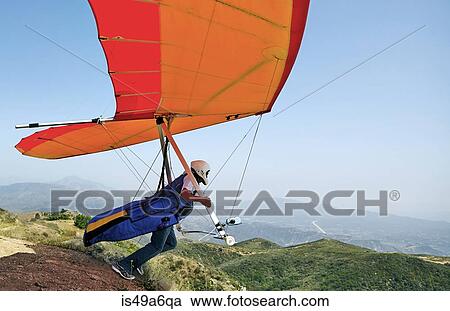Hang glider pilot taking off View Large Photo Image Stock Image - Hang glider pilot taking off. Fotosearch