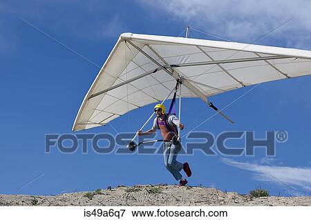 Hang glider pilot taking off View Large Photo Image Stock Photo - Hang glider pilot taking off. Fotosearch