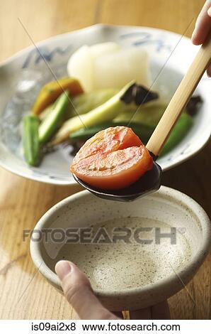 Heart-shaped tomato in ladle View Large Photo Image Stock Photo - Heart-shaped tomato in ladle. Fotosearch
