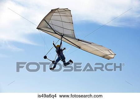 Man flying hang glider View Large Photo Image Picture - Man flying hang glider. Fotosearch