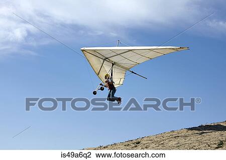 Man flying hang glider View Large Photo Image Stock Image - Man flying hang glider. Fotosearch