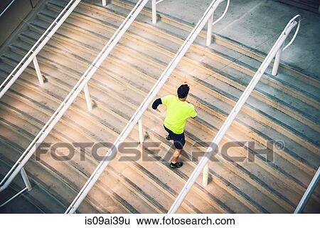 Stock Photograph - Mature male runner training on steps. Fotosearch