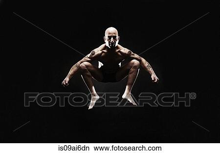 Picture - Mature man jumping mid air. Fotosearch