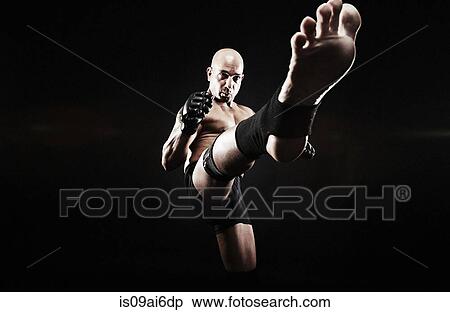 Stock Photography - Mature man kickboxing. Fotosearch