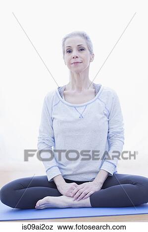 Stock Photo - Mature woman in lotus pose. Fotosearch